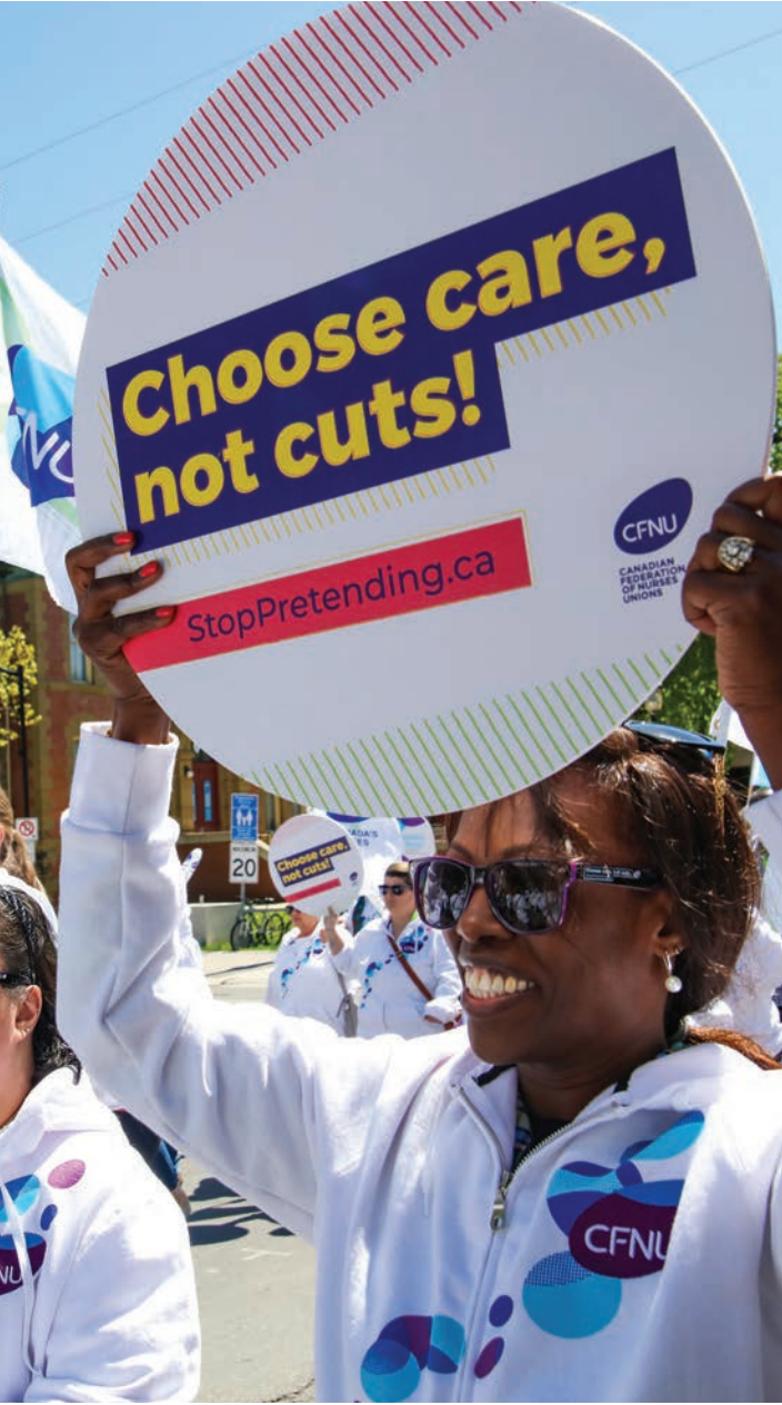 Campaign supporter holding a Choose care, not cuts placard