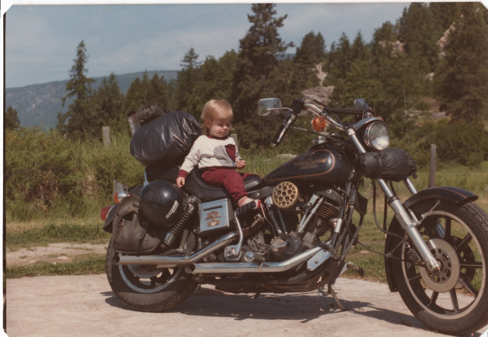 Young child sitting on a motorcycle outdoors