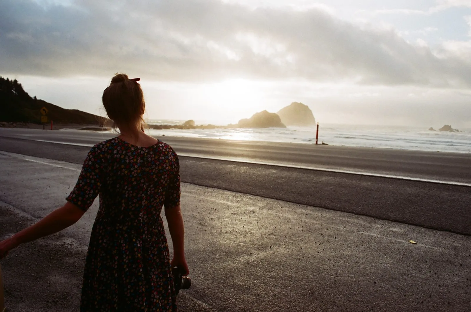 Original photograph of a woman looking toward a coastal landscape